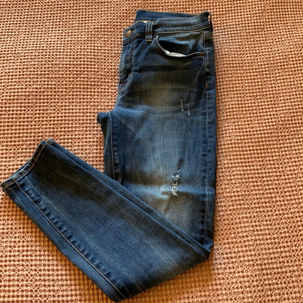 Medium wash skinny jeans with a few holes